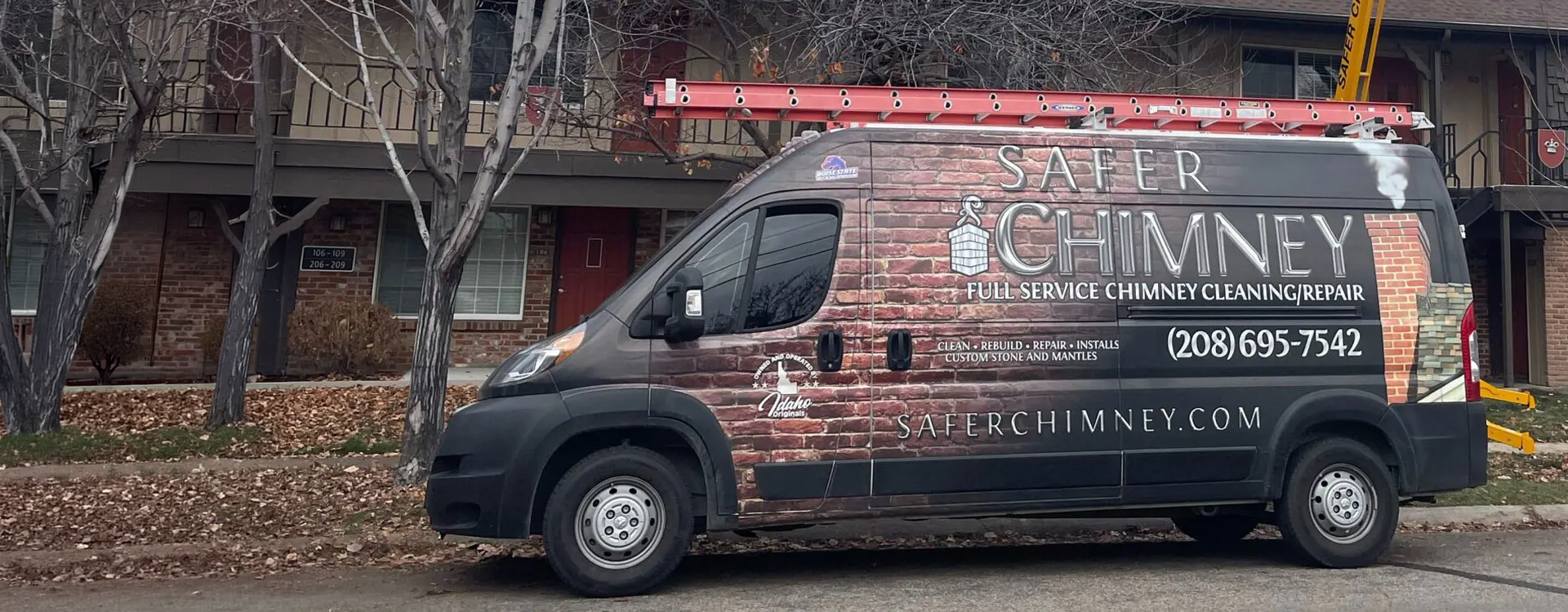 Safer Chimney LLC parks a service van outside a property for chimney cleaning in Boise, ID.