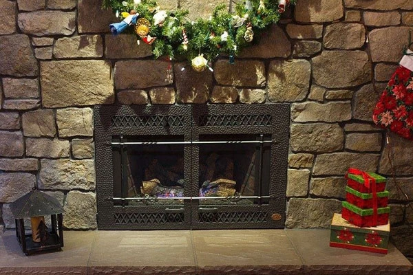 Holiday decorations surround a hearth upgraded by Safer Chimney LLC through fireplace repair services.