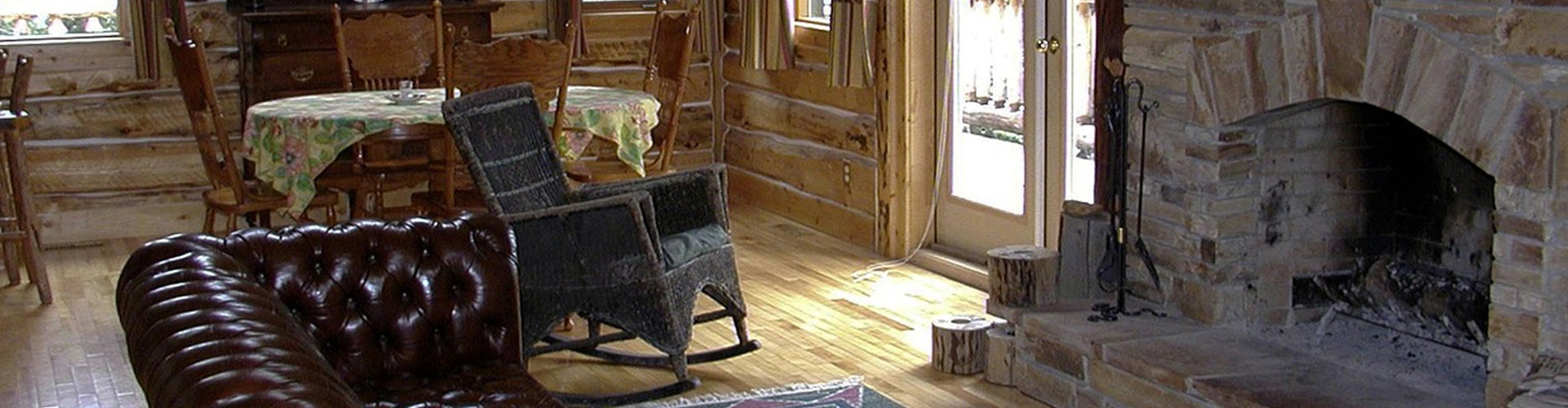 Couches and warm lighting frame a fireplace restored by Safer Chimney LLC for fireplace repair.